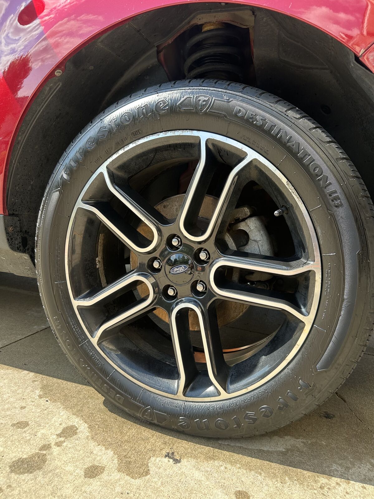 Ford Edge wheel before and after cleaning and tire dressing