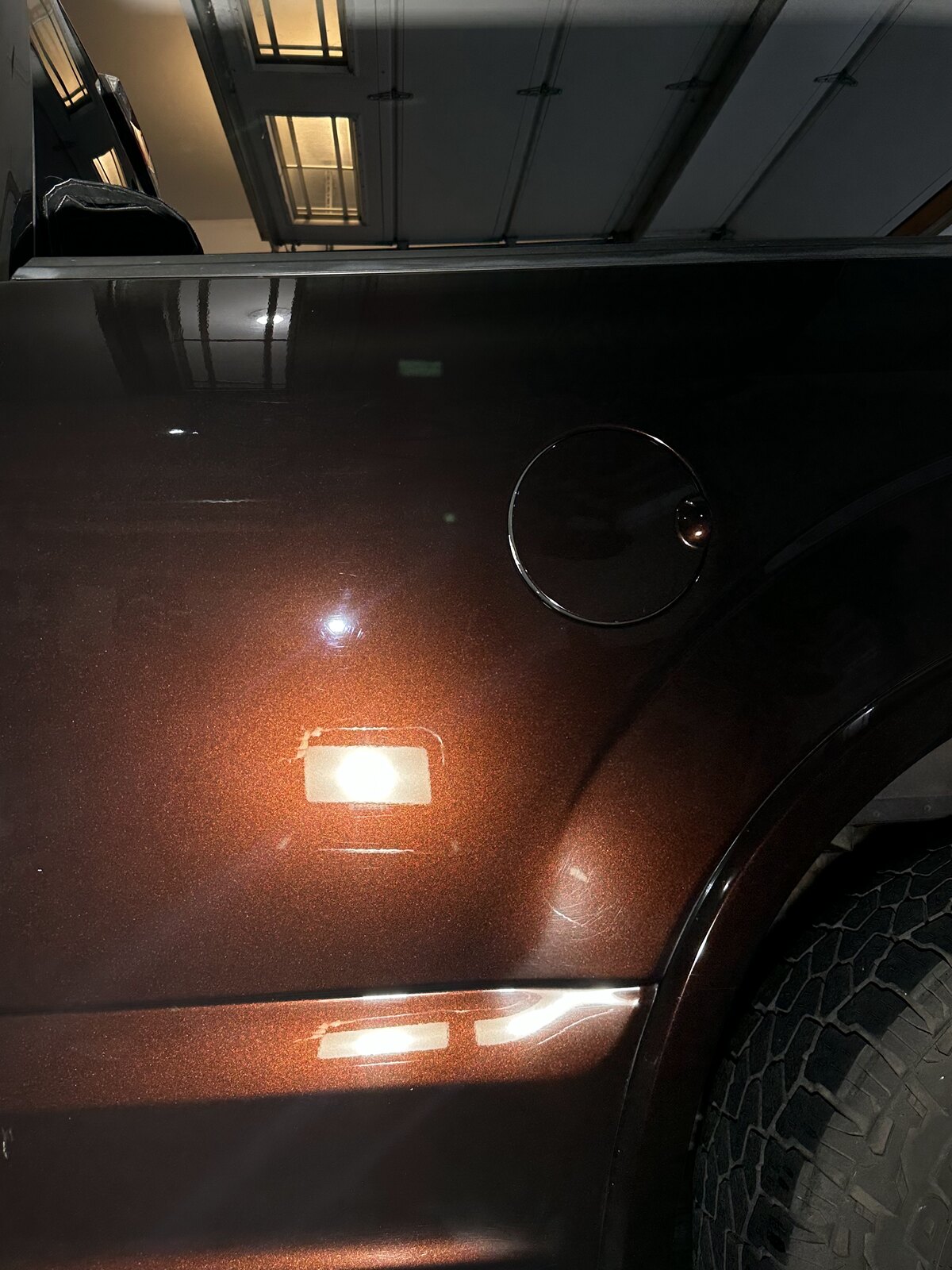 Ford truck rear panel before and after paint correction — swirl marks removed