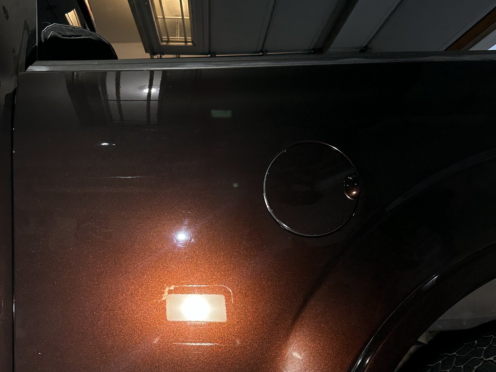 Ford truck rear panel before and after paint correction — swirl marks removed
