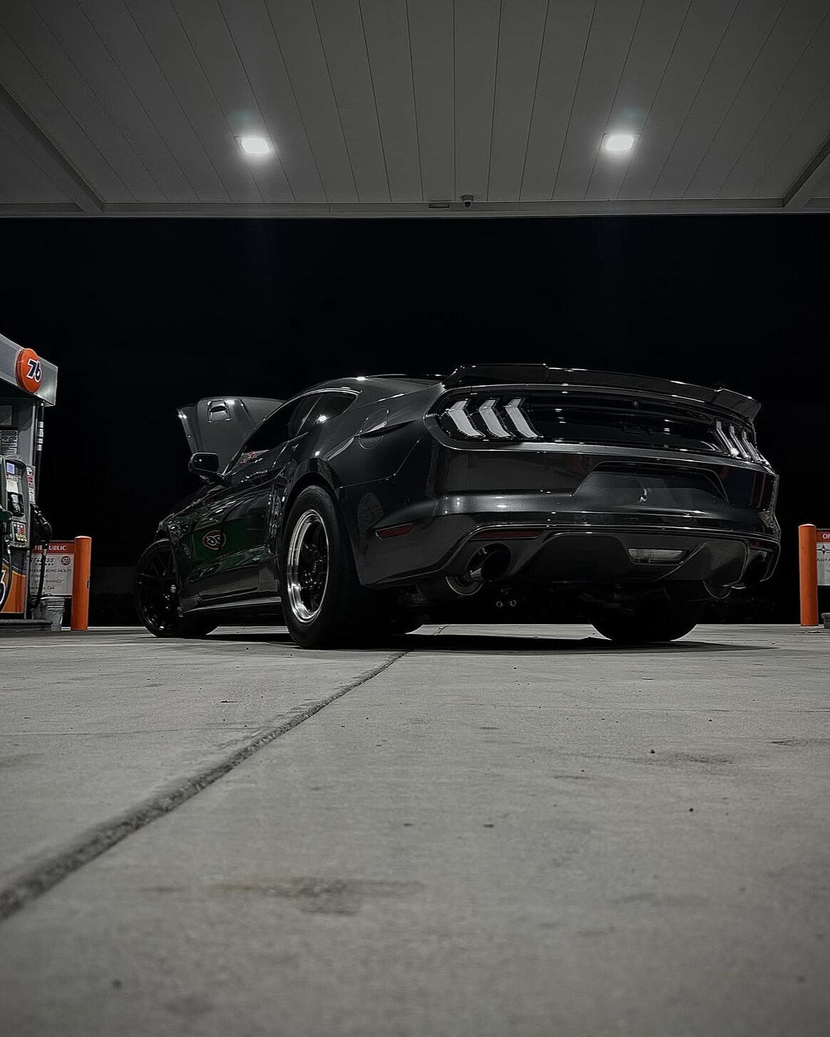 Freshly detailed Mustang GT under station lights at night