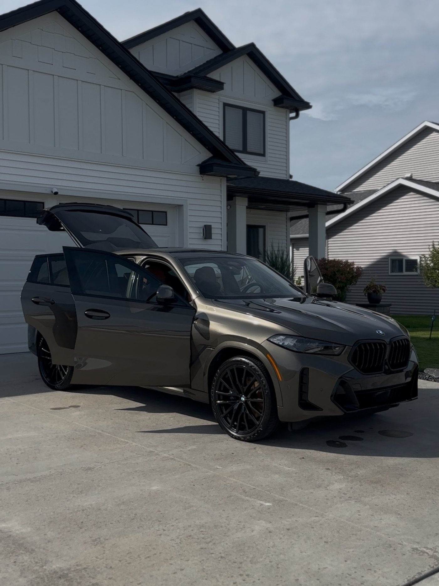 An SUV with its doors open in a driveway