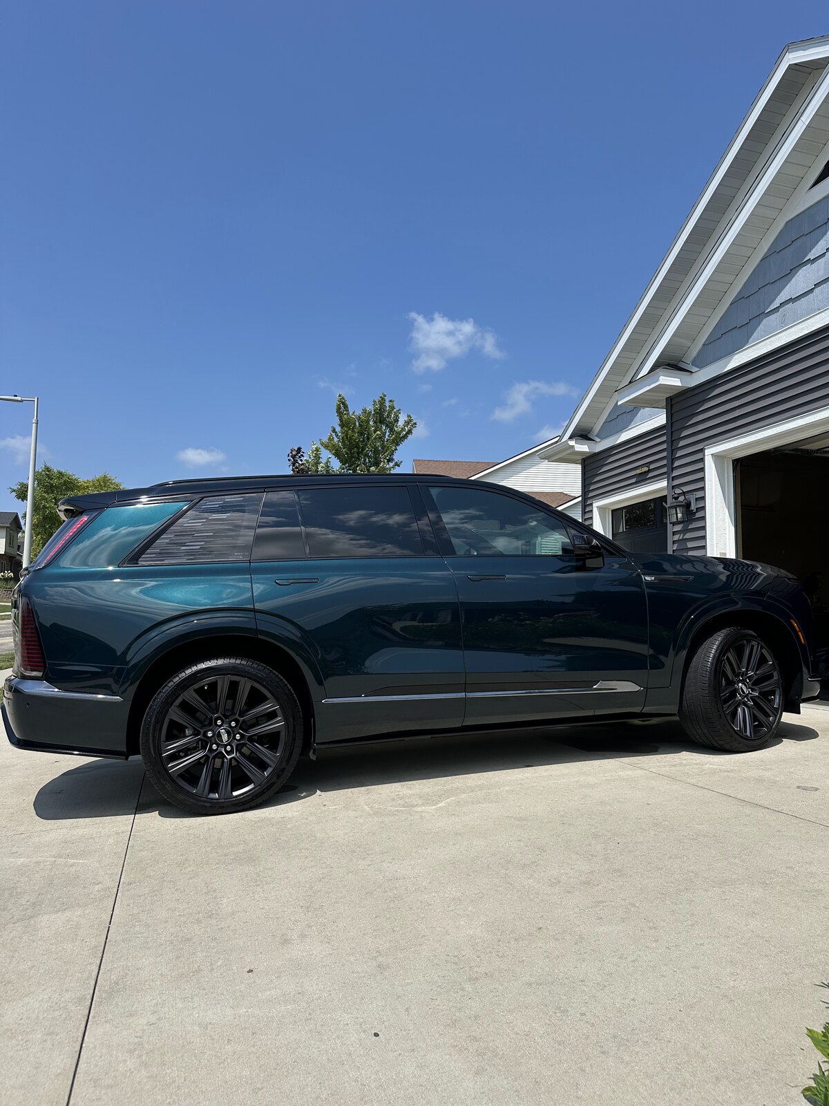 SUV covered in foam during a two-bucket wash, and the same SUV finished and gloss-dried